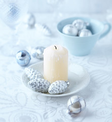 Candle and glass ornaments on a christmas table