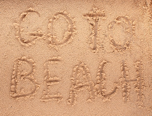 slogan on a sand. go to beach.