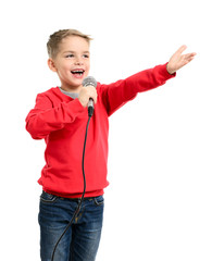 Little boy with microphone sings a song - 57980645