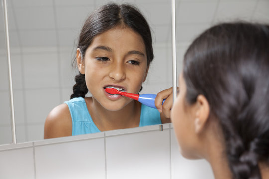 Young Teenage Girl Brushing Her Teeth