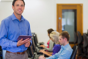 Teacher with students using computers in computer room