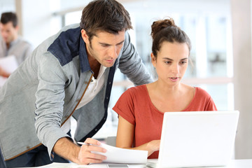 Business team in office working on laptop