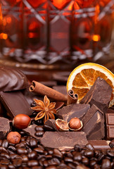 Mixture of pieces of chocolate spices and nuts , selective focus