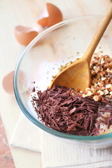 Chopped chocolate and walnuts in glass bowl