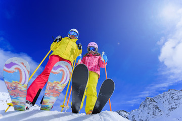Ski, sun and winter fun - skiers enjoying ski holiday