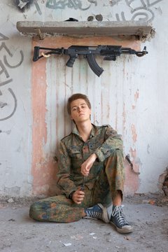 Teenager, boy in battle dress, of knife and rifle, Air Soft Gun