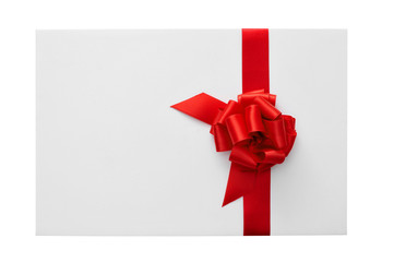 a blank card with a red ribbon bow with a copy-space