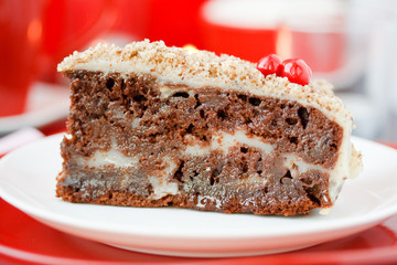 Cocolate cake with nuts. On a red background.