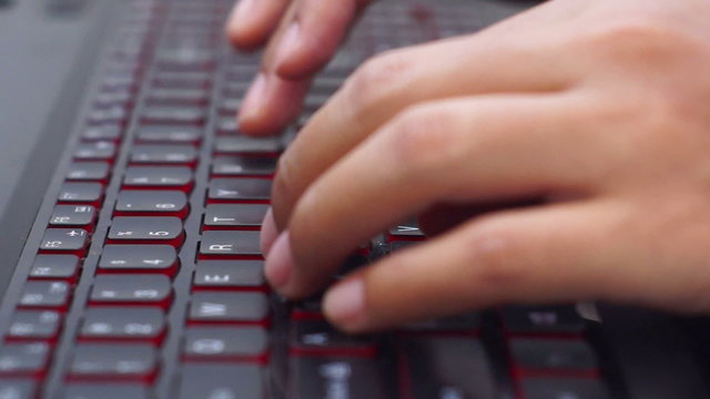 Person typing on a black laptop