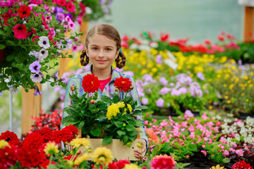 Gardening - girl holding flowers in garden center