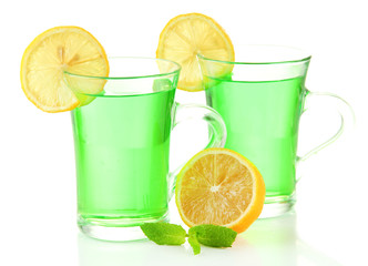 Two transparent cups of green tea with mint and lemon isolated