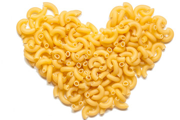 Italian pasta in the form of heart over white.