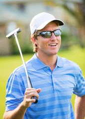 Athletic young man playing golf