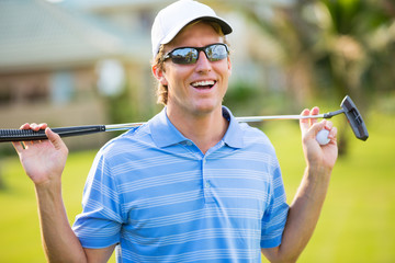 Athletic young man playing golf