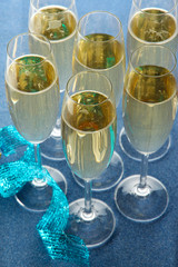 Glasses with champagne on shiny background