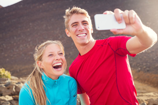 Young attractive athletic couple taking photo of themselves with