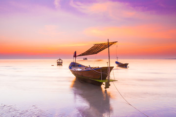 boat in the sea under sunset