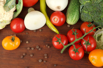 Fresh vegetables in basket on wooden table close-up