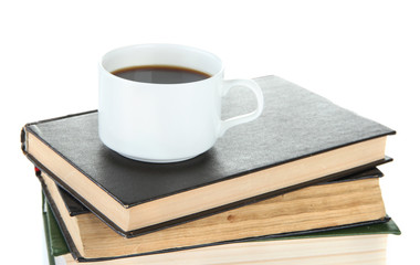 Cup of coffee and books isolated on white