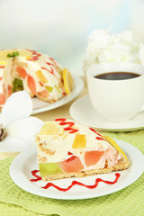 Delicious jelly cake on table on light background