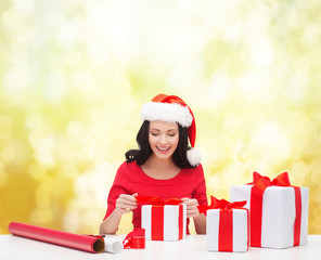 woman in santa helper hat with many gift boxes
