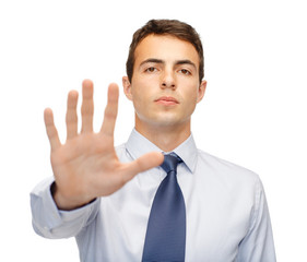 attractive buisnessman making stop gesture