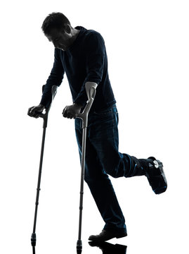 Injured Man Walking With Crutches Silhouette