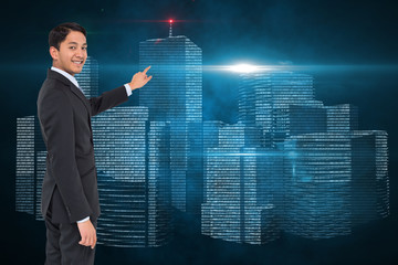 Composite image of smiling asian businessman pointing