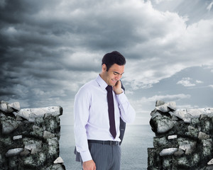 Fototapeta premium Composite image of smiling businessman standing