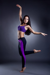 Graceful athletic dancer posing in studio