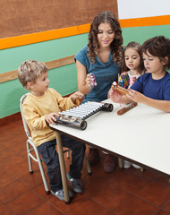 Teacher Playing Musical Instruments With Children