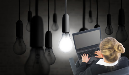 Composite image of businesswoman sitting on swivel chair with la