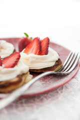 Pancakes with whipped cream and strawberry