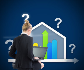 Composite image of businesswoman using laptop