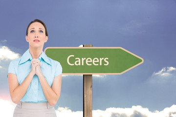 Composite image of troubled young businesswoman praying