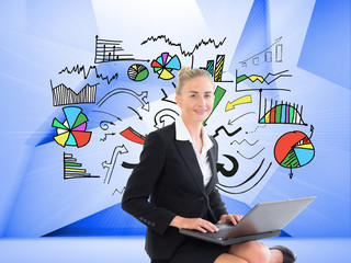 Composite image of businesswoman using laptop