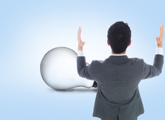 Composite image of businessman with arms raised