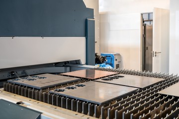 Machine cutting steel in a factory