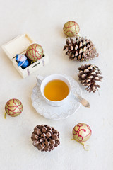 Obraz na płótnie Canvas Christmas composition with cup of tea, balls and bumps