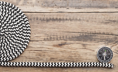marine roll ropes and compass on wooden background