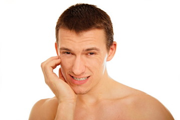 Obraz premium Young man suffering from a toothache on the white background
