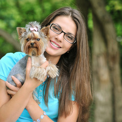 Young beautiful girl with her puppy outdoor