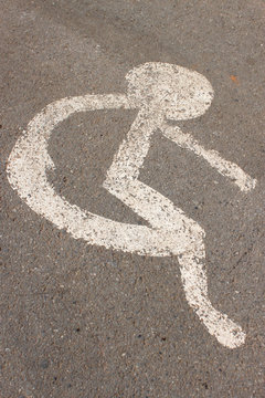 patient wheelchair sign on asphalt road
