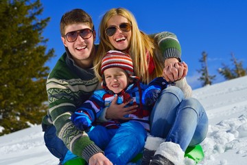 Fototapeta na wymiar family having fun on fresh snow at winter vacation