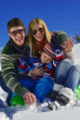 Fototapeta na wymiar family having fun on fresh snow at winter vacation