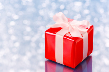 Red present on white sparkle background.