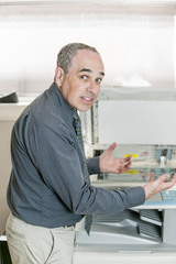 Man frustrated with photocopier