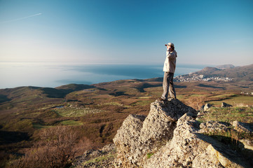 Man with mobile phone on the top of world