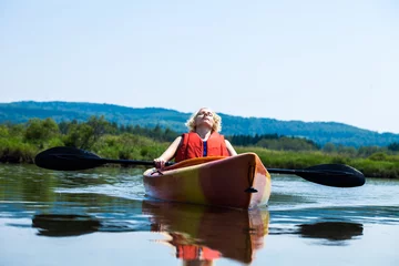 Foto op Canvas Woman Relaxing on a Kayak and Enjoying her Life © aetb