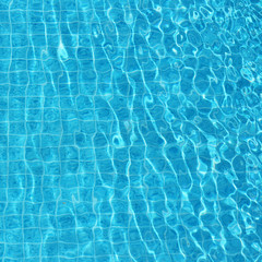 Fototapeta na wymiar Blue rippled water background in swimming pool